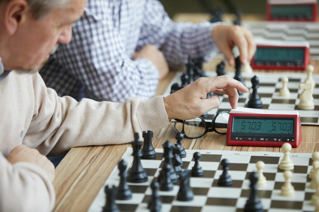 a photo of a chess player with a clock to show chess time limits
