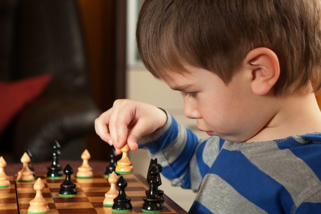 a photo of a child playing chess to show signs of chess talent