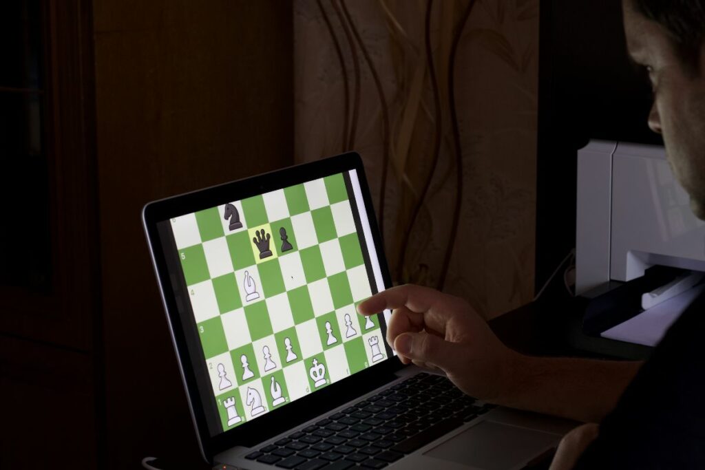 a photo of a player playing online chess to answer is chess an esport